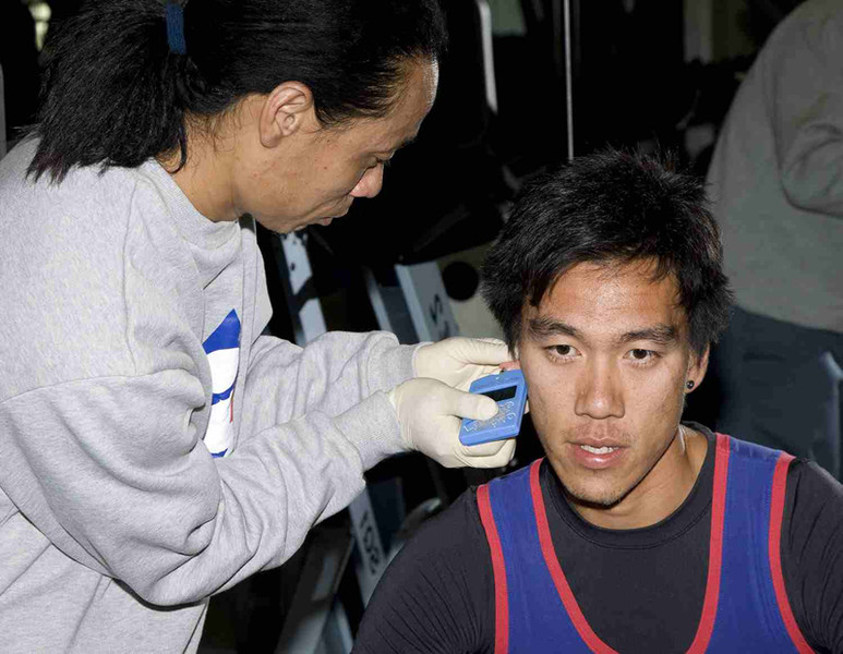 <p>HKSI sports science expert collects blood sample from rower Law Hiu-fung (right) after training which test data, indicating the training intensity, can be a good reference for coaches to adjust the elite training programme. This form part of the scientific training.</p>
