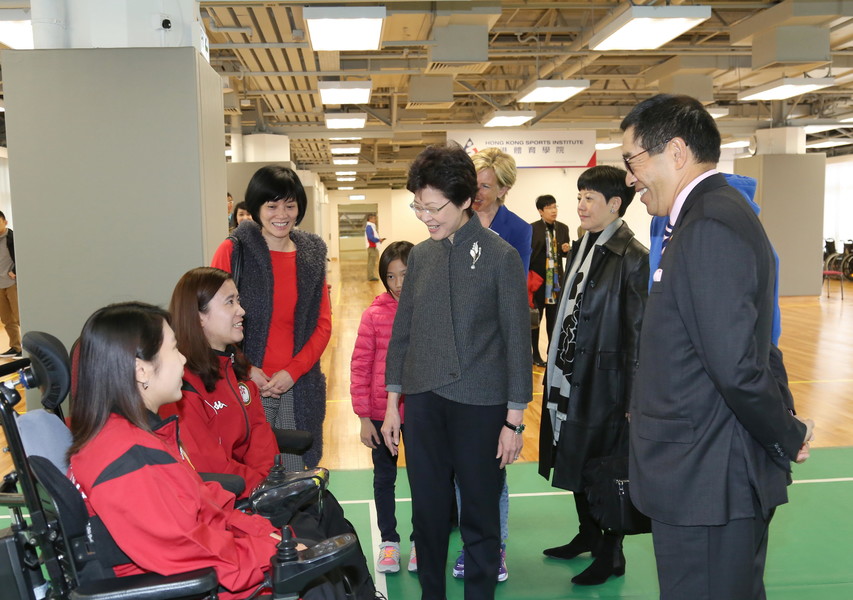 Mrs Carrie Lam GBS JP, Chief Secretary for Administration of the HKSAR Government was greeted by Boccia athletes Kwok Hoi-ying (2nd left) and Ho Yuen-kei (1st left) at the Hong Kong Jockey Club Sports Building.